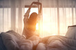 Leinwandbild Motiv Woman stretching hands in bed after wake up in the morning, Concept of a new day and joyful weekend.