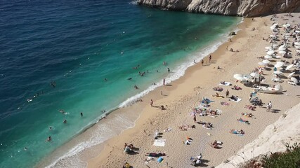 Wall Mural - Kaputas beach, Turkey. Beautiful turquoise beach with sun loungers and tourists in a Turkish resort in summer