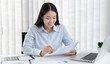 © Puwasit Inyavileart - Asian finance woman analyzing data on graphs