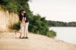 © Andriy Medvediuk - Young couple dancing and kissing at beach on sunny day Happy Romantic young Couple Enjoying Beautiful Sunset Walk on the Beach.