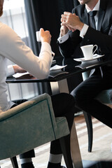 Sticker - Image of young businessman with cup of coffee communicating with colleague