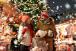 © Syda Productions - family, winter holidays and celebration concept - happy mother, father and little daughter with takeaway drinks at christmas market on town hall square in tallinn, estonia over snow