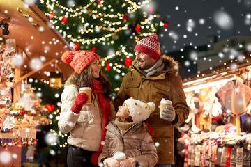 family, winter holidays and celebration concept - happy mother, father and little daughter with take