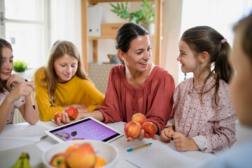 Canvas Print - Group of homeschooling children with teacher studying indoors, coronavirus concept.