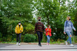 © Halfpoint - Group of young people crossing road outdoors in town, talking. Coronavirus concept.