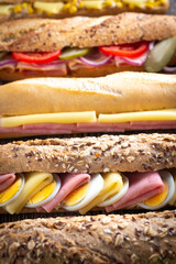 Assorted sandwiches on wooden background