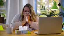 Obese Woman Working From Home Feeling Sick And Sneezing In Tissue