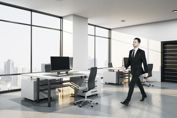 Wall Mural - Businessman walking in modern coworking office