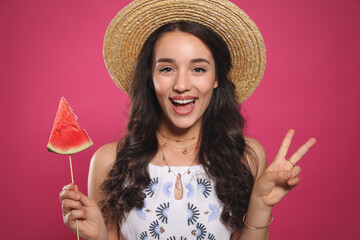 Wall Mural - Beautiful young woman with watermelon on pink background