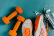 © KseniaJoyg - Fitness concept, essential running item, top view of running shoes, water, smartphone and headphones
