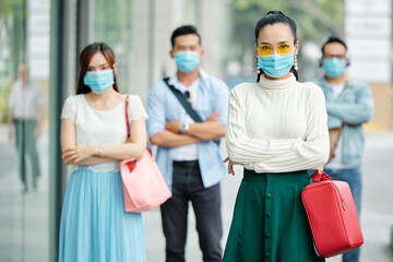 Sticker - Pretty elegant young woman in medical mask standing outdoors