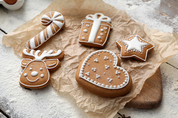 Delicious homemade Christmas cookies and flour on wooden table, closeup