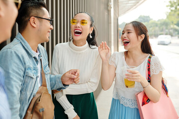 Sticker - Beautiful young Asian women laughing at jokes of their friend