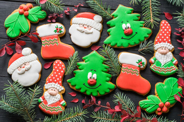 Christmas gingerbread cookies in the shape of christmas toys on black wooden table. New year, christmas concept