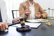 © snowing12 - lawyer or judge meeting with client consulting help discussing contract paper agreement.