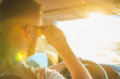 © johnalexandr - A man sits behind the wheel of his car on a sunny day