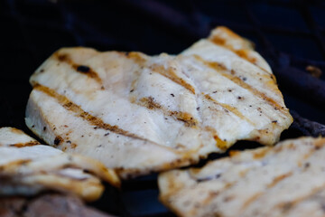 Wall Mural - Close up image of traditional chicken fillet on a braai/bbq in South Africa on an open fire