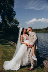 Walking the bride and groom outdoors. Beautiful summer photo session in nature.