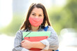 © Antonioguillem - Happy student with mask posing in the street