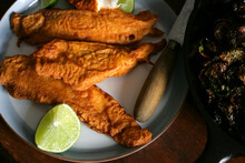 Golden Battered Fried Fish Fillets With Lime On Plate