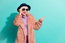 Photo Of Cute Old Woman Dressed Vintage Outerwear Cap Eyewear Pointing Empty Space Isolated Turquoise Color Background