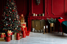 Beautiful Festively Decorated Room With A Christmas Tree. Cozy Living Room In Red Tones With A Stylish Classic Decor.