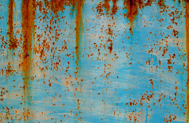 Texture of a rusty metal surface: dark blue, blue, aged cracked paint. Abstract background.