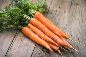 Fresh carrots bunch on rustic background. Healthy vegan vegetable food.