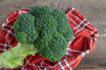 Raw broccoli on rustic wooden background