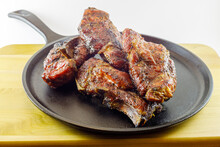 Smoked Country Style Pork Ribs Served On A Seasoned Cast Iron Skillet. Selective Focus, Background Blur And Foreground Blur 
