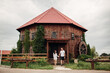 © Andriy Medvediuk - Couple in love walks near a large wooden mill on summer day. man and woman are having fun outdoors.