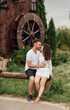 © Andriy Medvediuk - Couple in love walks near a large wooden mill on summer day. man and woman are having fun outdoors.