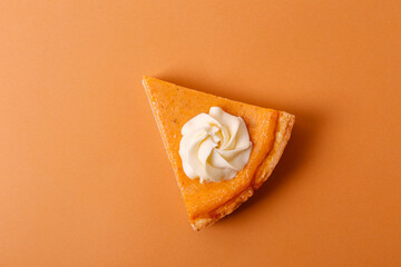 Wall Mural - Traditional thanksgiving food on wooden table. Orange delicious homemade pumpkin pie with crust and decorative items. Thanksgiving table setting concept.Top view, close up, copy space, background.