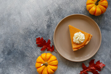 Wall Mural - Traditional thanksgiving food on wooden table. Orange delicious homemade pumpkin pie with crust and decorative items. Thanksgiving table setting concept.Top view, close up, copy space, background.