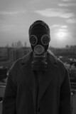 Fototapeta  - 
man in a gas mask on the background of a big city