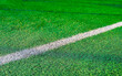 © andov - White stripe on green grass, on the football field. Football field with markings.