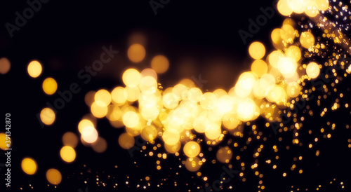 Fotomural Weihnachtlich Goldenes Bokeh auf einem schwarzem Hintergrund mit einem Licht Schimmer