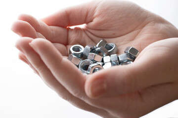 screw-nuts in hands on a white background