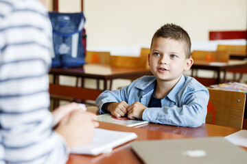 Wall Mural - Young boy in elementary school doing some test.Educational concept.	
