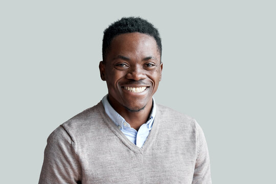 smiling cheerful young adult african american ethnicity man looking at camera standing at home offic