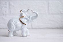 White Elephant With A Small Elephant On Its Back Porcelain Figurine On A White Background With Space For Text