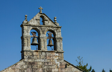 Bells in abandoned church with a beautiful blue sky