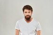 © SHOTPRIME STUDIO - Bearded man gesturing with hand white cropped t-shirt studio lifestyle