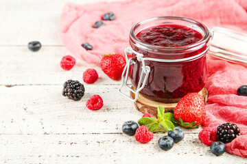 Canvas Print - Sweet raspberry jam in glass jar with ripe berries on white wooden table