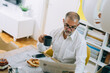 © cherryandbees - middle aged man having breakfast at home