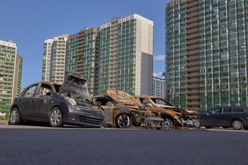 Wall Mural - city burned cars after a fire in one of the city's districts