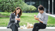 © JIACHUAN LIU/Stocksy - Businessman And Businesswoman Eating Lunch Together