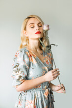 Portrait Of A Blonde Girl With A Rose Wearing A Red Lipstick And A Pastel Illustrated Dress