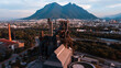 © Yakov Knyazev/Stocksy - old-school factory in front of the mountain