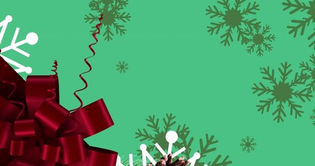 Wall Mural - Animation of red present ribbon and snow falling on green background